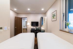 a hotel room with a bed and a television at Soosong Guesthouse Gwanghwamun Myeongdon g in Seoul