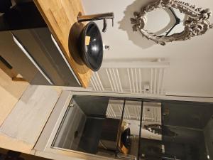 a mirror and a pan hanging above a window at comfortable village house in Le Fossat