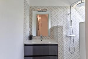a bathroom with a sink and a mirror at Maison bretonne de charme in Plumergat +13 photos