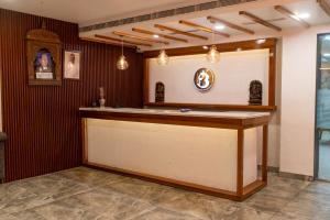 a bar in a room with red walls at Hotel Bobina in Gorakhpur