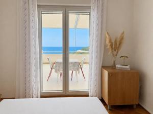 a bedroom with a bed and a view of the ocean at Apartments Marija Magdalena in Hvar