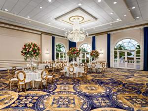 a banquet room with tables and chairs and a chandelier at Fairmont El San Juan Hotel in San Juan +289 photos