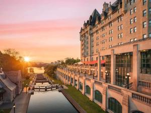 a view of a river between two buildings at Fairmont Chateau Laurier in Ottawa