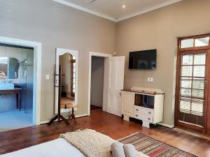 a living room with a tv on a wall at The Theatre in Bedford