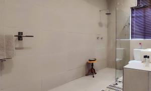 a white bathroom with a shower and a toilet at The Theatre in Bedford +18 photos