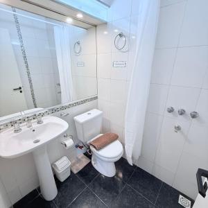 a bathroom with a toilet and a sink and a shower at G8 Hermoso Monoambiente con Cochera 2 huéspedes in Villa Ángela +11 photos