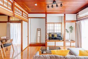 a living room with a couch and a tv at AO Niigata in Niigata