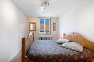 a bedroom with a bed and a window at Appartement Aime La Plagne in Aime-La Plagne