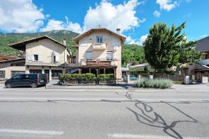 a car parked in front of a building on a street at Appartement Aime La Plagne in Aime-La Plagne