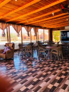 a restaurant with tables and chairs and a checkered floor at Reef Beach Camp in Nuweiba