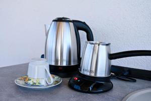 affeepot and a coffee maker on a counter at Villa Mladost Luxury in Veles