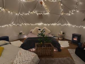 a room with two beds and lights in a tent at Pewsey Countryside Dome - Dog Friendly - Fire pit in Pewsey +4 photos