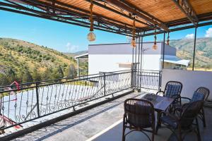 a balcony with a table and chairs and a view at Villa Mladost Luxury in Veles