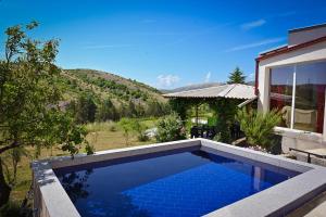 a swimming pool in the backyard of a house at Villa Mladost Luxury in Veles
