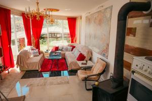 a living room with a couch and a fireplace at Villa Mladost Luxury in Veles