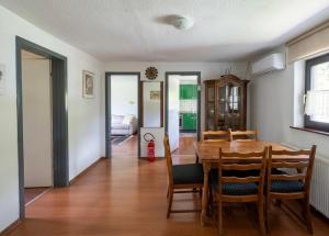 a dining room with a wooden table and chairs at Hava apartment in Sarajevo