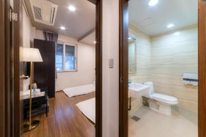 a bathroom with a toilet and a sink at Soosong Guesthouse Gwanghwamun Myeongdon g in Seoul +164 photos