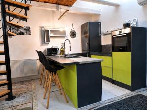a kitchen with a colorful island in the middle at Ady Házikó in Pécs