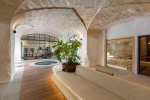 a living room with a couch and a potted plant at Mohala Boutique Hotel in Diso +96 photos