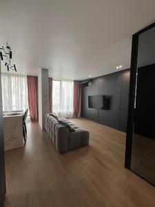 a living room with a couch and a flat screen tv at Manhattan Comfort in Ivano-Frankivsk