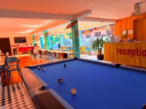 a pool table in the middle of a room at Vang Vieng Dragon House in Vang Vieng