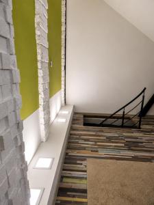 a staircase in a room with a green wall at Ady Házikó in Pécs