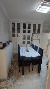 a dining room with a table and chairs in a kitchen at Maison Lyne in Hammamet