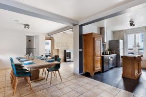 a kitchen and dining room with a table and chairs at Gîte Le Rabelais in Thésée