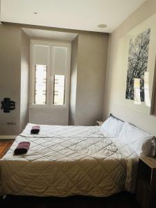 a bedroom with a bed with two towels on it at M-Room in Málaga
