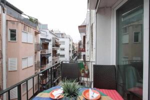 a balcony with a table and chairs on a balcony at Maribeach3 Sitges in Sitges