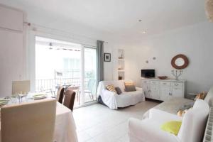 a white living room with a bed and a couch at Maribeach3 Sitges in Sitges