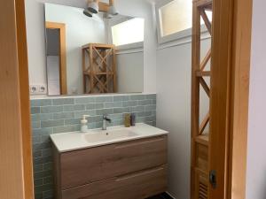 a bathroom with a sink and a mirror at Maribeach3 Sitges in Sitges +18 photos