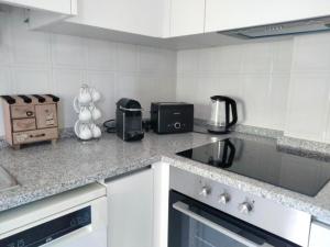 a kitchen with a counter top with a toaster and a appliance at Garça-Real 2 in Vale de Madeiros +3 photos