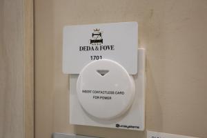 a white toilet with a sign on it at DEDA & FOVE in Naples +97 photos