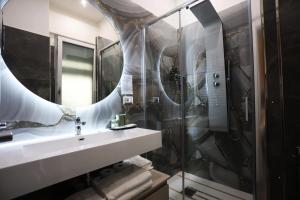 a bathroom with a shower and a sink and a mirror at DEDA & FOVE in Naples