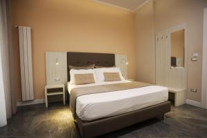 a bedroom with a large bed with white sheets and pillows at DEDA & FOVE in Naples