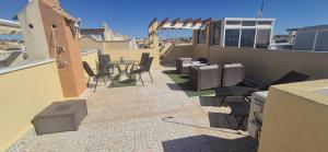 a patio with a table and chairs on a balcony at La Florida Apartment Near Emerald Isle Complex in Orihuela Costa
