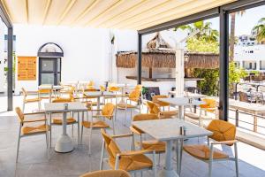 a restaurant with tables and chairs and windows at Casa Colore Boutique House in Bodrum City