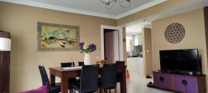 a dining room with a table and a tv at Hanem in Cedit +11 photos