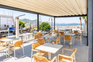 a restaurant with tables and chairs and a view of the water at Casa Colore Boutique House in Bodrum City