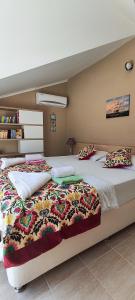 a bedroom with two beds and a book shelf at Hanem in Cedit