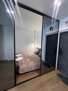 a bedroom with a bed inside of a glass wall at Manhattan Comfort in Ivano-Frankivsk