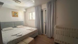 a bedroom with a bed and a window at Apartment Orange Blossom First Line & Pool 2 in Bijela +16 photos