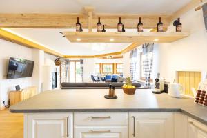 a kitchen with bottles of wine on a shelf at Chalet Au in Fischen
