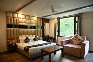 a bedroom with a bed and a chair and a window at The Hoften Blue Magnets, Dalhousie in Dalhousie +80 photos