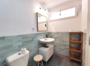 a bathroom with a sink and a toilet and a mirror at Maribeach Sitges in Sitges +14 photos