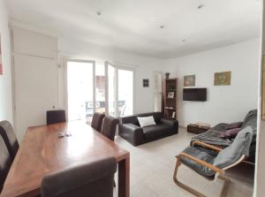 a living room with a table and a couch at Maribeach Sitges in Sitges