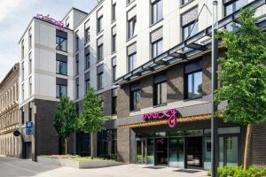 a building with a pink bow sign on it at Moxy Budapest Downtown in Budapest