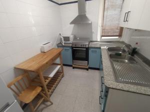 a kitchen with a stove and a sink in it at Maribeach2 Sitges in Sitges +12 photos