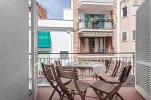 a patio with chairs and a table on a balcony at Maribeach2 Sitges in Sitges